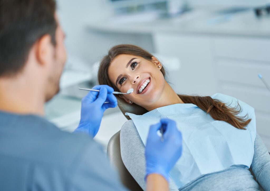 Dentist discussing dental implants with a patient before an MRI, explaining safety and imaging considerations.