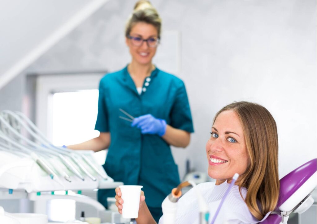 Patient discussing porcelain veneer treatment with a dentist during a consultation about veneer costs by location.