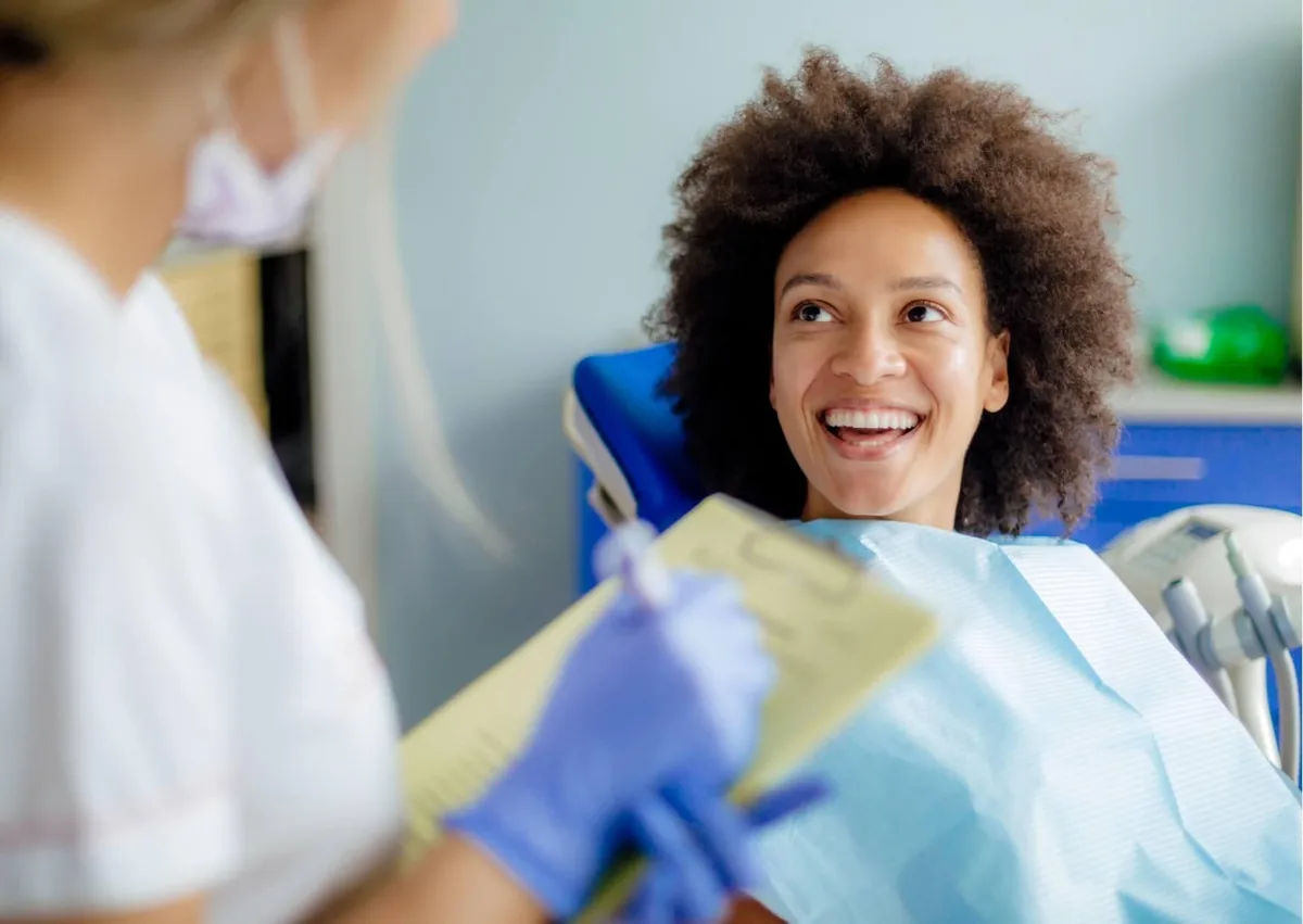 Patient discussing dental bonding costs and treatment options with a dentist.