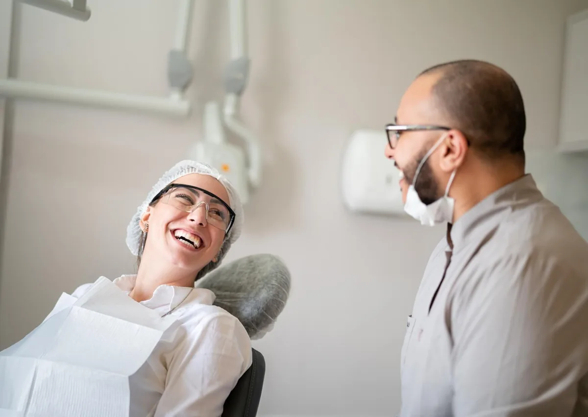 Dentist discussing tooth-colored fillings with a patient during a dental visit.