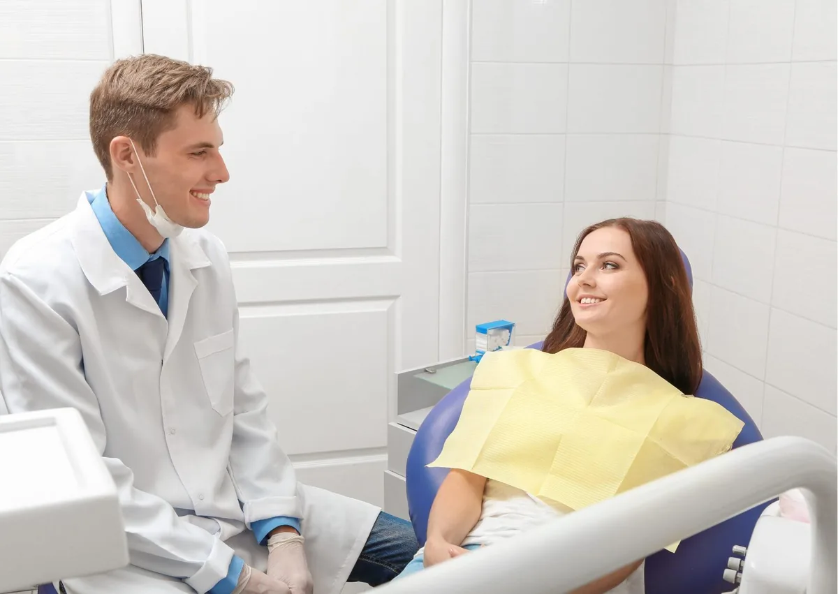 Dentist discussing dental crown options and costs with a patient during a consultation.