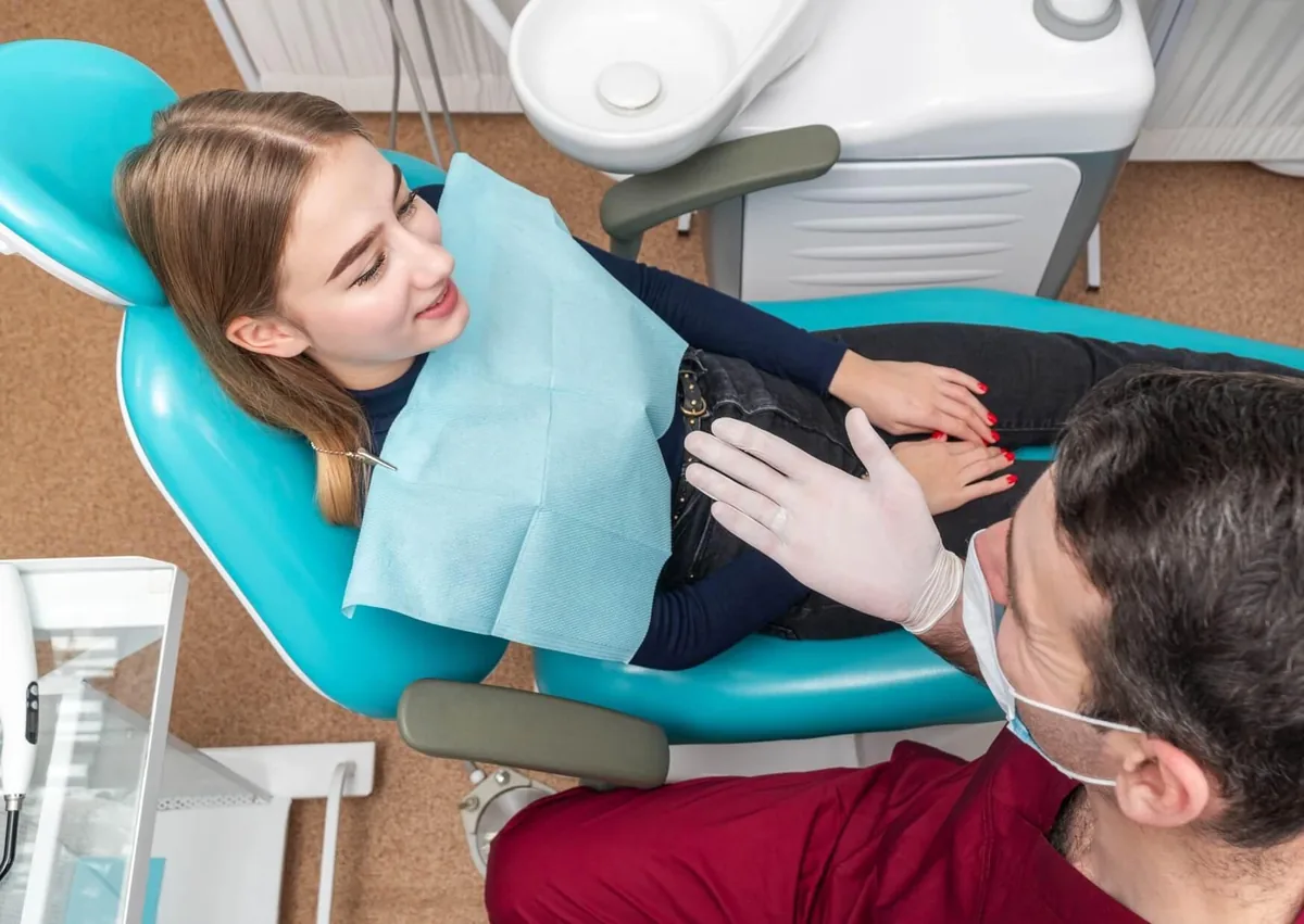 Dentist discussing gum contouring treatment options with a patient during a consultation.