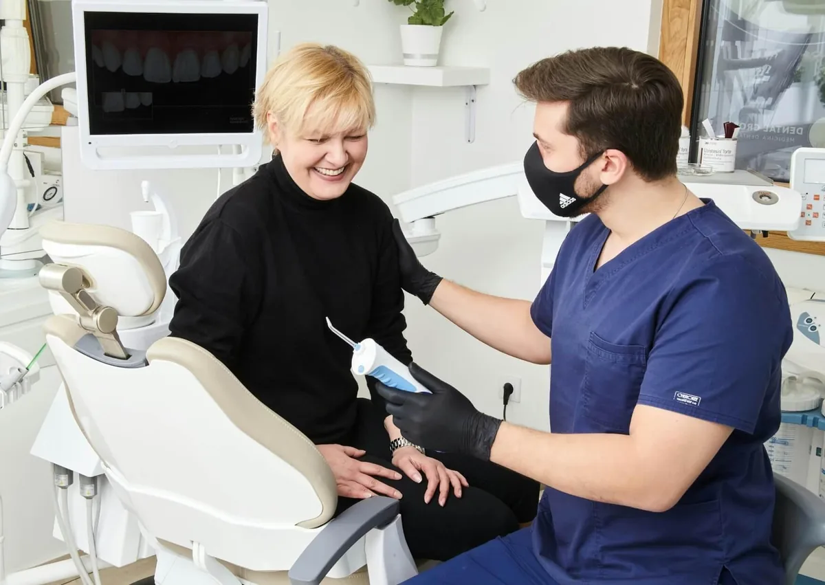 Dentist discussing tooth contouring cost and cosmetic treatment options with a patient.